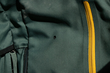 Backpack with a burn hole from a cigarette