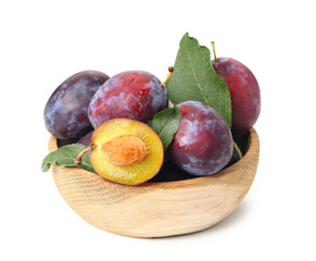 Wooden bowl with fresh ripe plums on white background