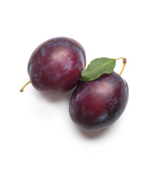 Fresh ripe plums with leaf on white background