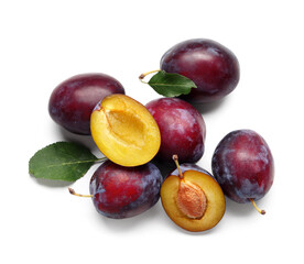 Fresh ripe plums with leaves on white background