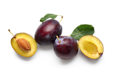 Fresh ripe plums with leaves on white background
