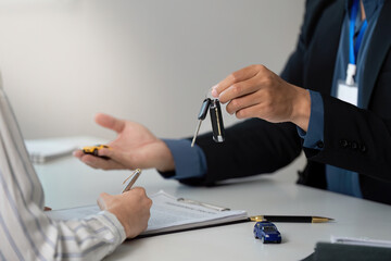 Key Handover. Professional presenting car keys to client during insurance consultation.