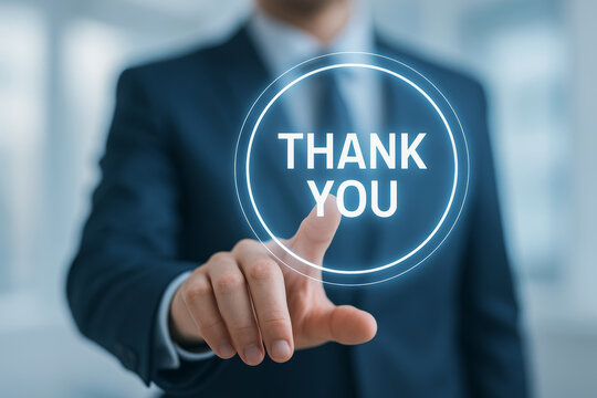 A businessman is gesturing towards a digital display that reads "THANK YOU," conveying appreciation in a modern, professional setting.