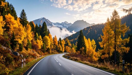 Scenic Curving Mountain Road with Autumn Foliage and Misty Alpine Peaks
