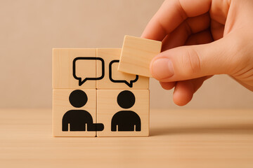 A hand places a block in a conversation-themed puzzle, showcasing communication between two figures with speech bubbles.