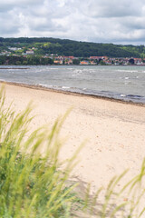 The stunning beach view in Southern Sweden and charming coastal town under a beautiful cloudy sky, Bastad, Sweden