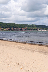 The stunning beach view in Southern Sweden and charming coastal town under a beautiful cloudy sky, Bastad, Sweden