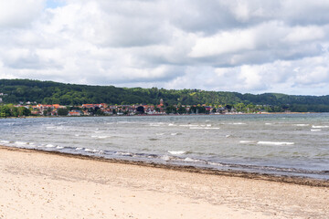 The stunning beach view in Southern Sweden and charming coastal town under a beautiful cloudy sky, Bastad, Sweden