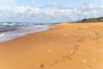 The stunning beach view in Southern Sweden and charming coastal town under a beautiful cloudy sky, Bastad, Sweden