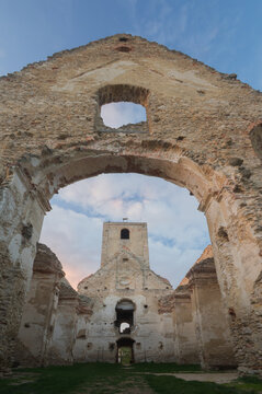 View of the weathered stone ruins and archway frame a distant church tower under a serene sky, Katar&Atilde;&shy;nka (p&Atilde;&ordm;tnick&Atilde;&copy; miesto), Trnavsk&Atilde;&frac12; kraj, Slovakia.