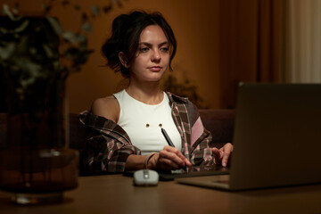 beautiful graphic designer woman working at home office remotely using digital graphic tablet and laptop