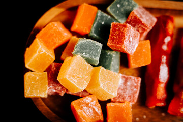 Colorful assortment of Turkish delights lokum on a wooden platter in a cozy setting