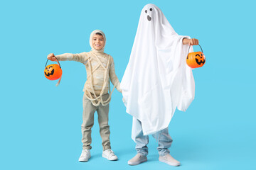 Boys dressed for Halloween on blue background