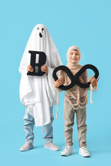 Boys dressed for Halloween with word BOO on blue background