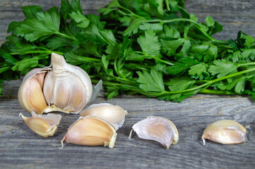 fresh garlic and parsley on a wooden background
