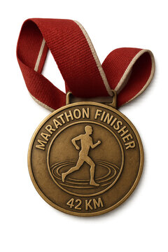 Marathon finisher medal hanging on red ribbon with transparent background