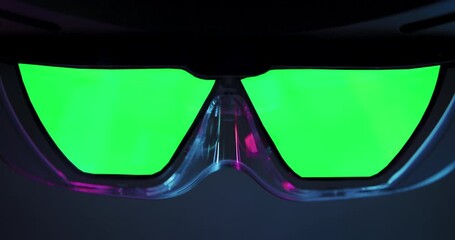 AR glasses with bright green chroma key lenses, prepared for digital compositing or post-production VFX insertion in futuristic tech scenes.