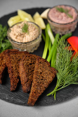 Appetizing food arrangement with bread, dips, and fresh herbs