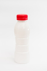 
A generic white plastic bottle with a bold red cap, isolated against a dark background, perfect...