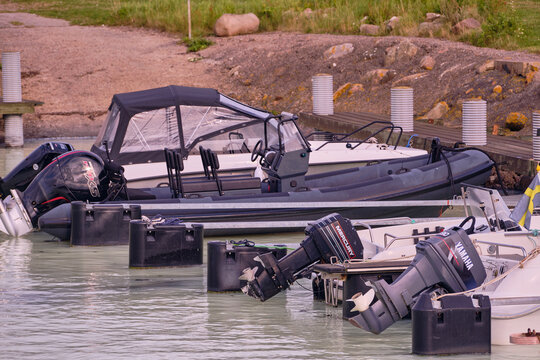 Row of boats with Mercury and Yamaha outboard motors docked in Vistorps Hamn