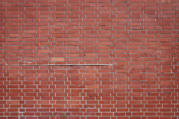 A straight-on, high-resolution photograph of a classic red brick wall, ideal for use as a texture or digital background.
