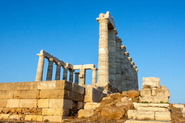Temple of Poseidon ruins on stone base in Sounion, Attica, Greece.
