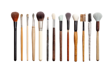 A horizontal row of various makeup brushes.  Different sized, shaped, and colored brush heads on wooden or dark handles.  Professional makeup tools
