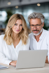Mature executive manager collaborating with colleague in modern office environment