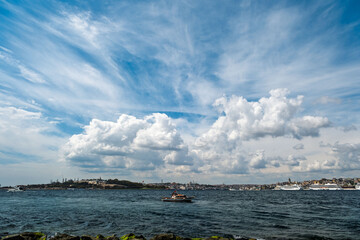 A boat is in the middle, with Galata Tower in the background and cruise ships on the right. The silhouettes of Topkapı Palace and the Sultanahmet Mosque are visible on the left. taken from Maiden's T.