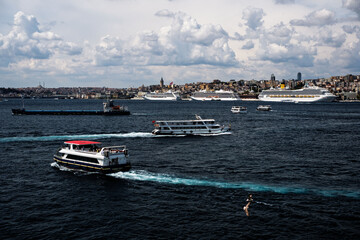 Costa Fortuna cruise ship and other little big ships on the Bosphorus of Istanbul. Ferries and passenger boats are visible cruising the Bosphorus, with large cruise ships in the background. Galata Tow