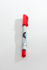 A red marker pen with a metallic body, isolated on a clean white background, symbolizing writing,...