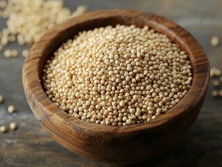 Close-up of uncooked quinoa grains in a wooden bowl, showing their tiny round texture