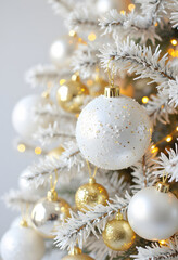 White and Gold Christmas Ornaments on Festive Tree - Close-up of a beautifully decorated Christmas tree, adorned with white and gold holiday ornaments.