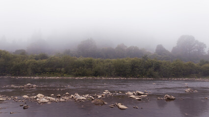 Morning September fog over a mountain river