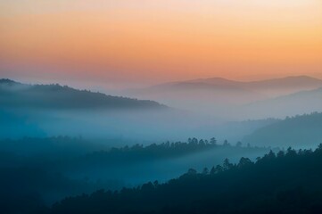Obraz premium Foggy morning in the mountains with silhouettes of hills.