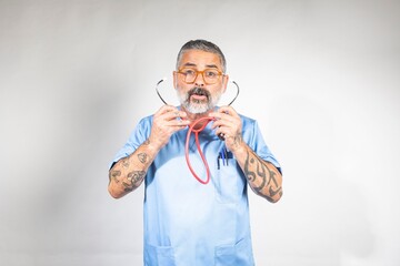 Tattooed Doctor in Blue Scrubs with Stethoscope