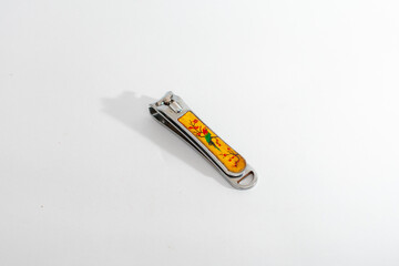 A decorated metal nail clipper, isolated on a clean white background, symbolizing personal...