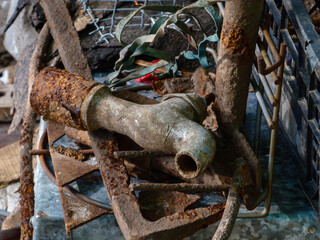 A rusty old tap on a junk heap.