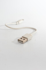 A white USB cable with a standard USB-A connector, isolated on a clean white background,...