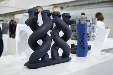 Object printed on 3D printer from molten plastic powder close-up. Model of black color printed on...