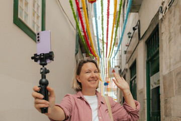 Vlogger traveler woman recording video on phone share via app travel vacation. Middle age woman...