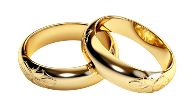 Exquisite engraved gold wedding rings exchanged by the bride and groom in a love filled wedding ceremony, adding sophistication and love to their marital celebration.