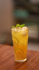 Lychee aloe vera tea garnished with mint leaves, and fresh lychee fruit