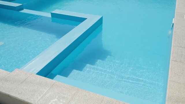 clear blue water in swimming pool with steps, slow motion
