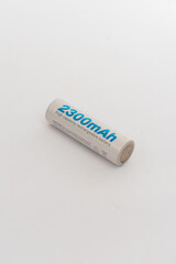 A white rechargeable battery with blue text, isolated on a clean white background, symbolizing...