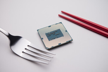 US fork, Chinese chopsticks and CPU on white background. US vs China chip war or tech war, microchip semiconductor industrial concept. US restrict and control chip export to China.