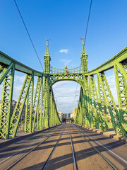 Liberty Bridge in Budapest, Hungary, standing majestically under a clear blue sky, showcasing its...