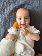 Baby Smiling with Plush Duck Toy
