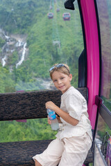 Family with children, visiting the Golden bridge with big golden hands holding it in Da Nang, Ba Ha...