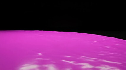 Pink Paint Puddle Flowing Slowly on a Reflective Black Surface During Daytime